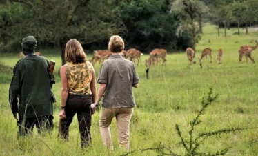 A couple on a guided walking safari in Lake Mburo National Park.