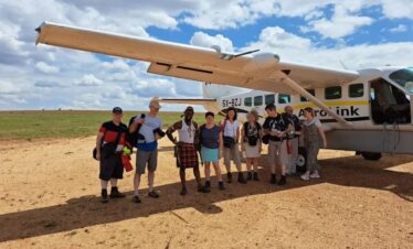 Tourists getting ready for a fly-in safari over Uganda's stunning landscapes. Aerial view of wildlife and vast terrain.